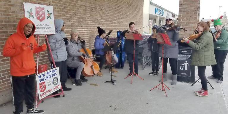 Allegro members freezing with our Salvation Army Friends recently outside of Stop n’ Shop on Dec. 21.