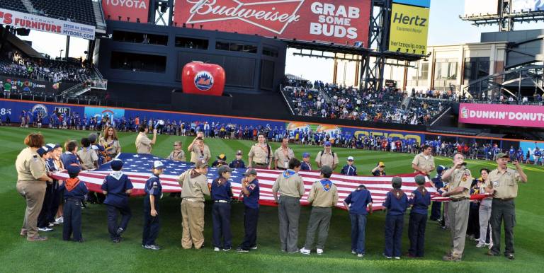 Standing ready for the playing of the National Anthem.