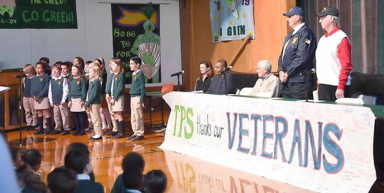 Veterans rose when their service song was sung by Tuxedo Park School third grade students during the Armed Forces Medley.