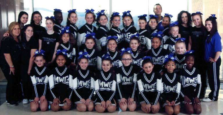 The Pee Wees, in the back row from the left: Coaches Caila Friedman and Debra Jean McShea, Hannah West, Sofia Omar, Maddison Hickey, Gianna Tondo, Hannah O&#xfe;&#xc4;&#xf4;Grady, Marissa Mitchell, Hannah McShea, Victoria Basso, Coach Ted Nelson, Calina Padilla-Schweizer, Coach Dorian Tondo and Trainer Brianna Evans. Middle row: Coach Lori Calderone, Trainer Halle Smith, Trainer Sami MacFadden, Azules Rule, Deanna Calderone, Grace Kelly, Cassidy Weitzer, Arianna Nobles, Hannah Whitfield and Samantha Weinberg. First row: Daniella Guerra, Emily Tejada, Lauren Karas, Angela Dimare, Kaitlyn Trumper, Jade Alvarado, Elise Gaviola and Lauryn Laramore.