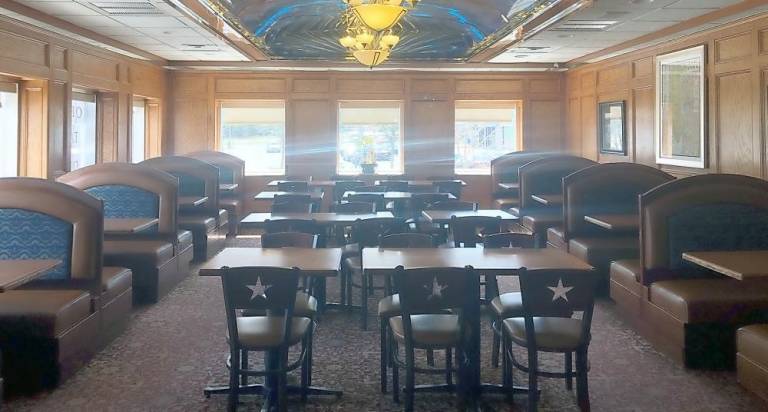 The normally bustling Empire Diner in Monroe is empty, dark and closed, except for its modified hours of 11 a.m. to 2 p.m. and again from 5 to 9 p.m.