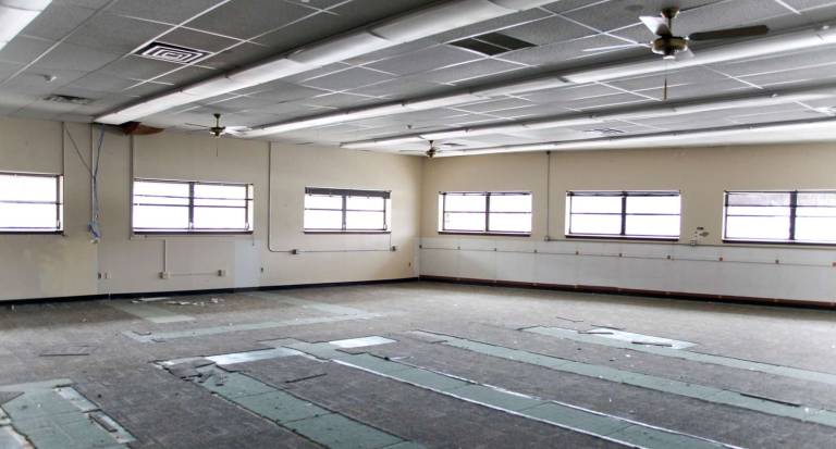 The day after the removal of the books and shelves, the library's main collection space is vacant.