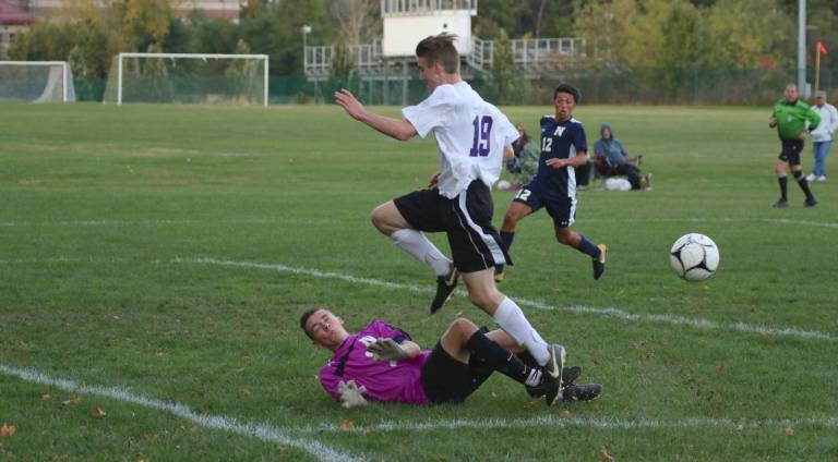 Owen Kelly (#19) leaps over the NFA goalie after he came out to make a save.