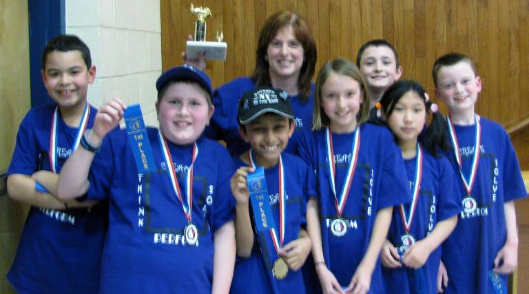 Division I, Problem 3 winners, from the left: William Carter, Deaglan MiMurro, Rajan Patel, Coach Lauren Phillips, Alexi Berges, Ronan Fitts, Emily Wang and Sean McGee.