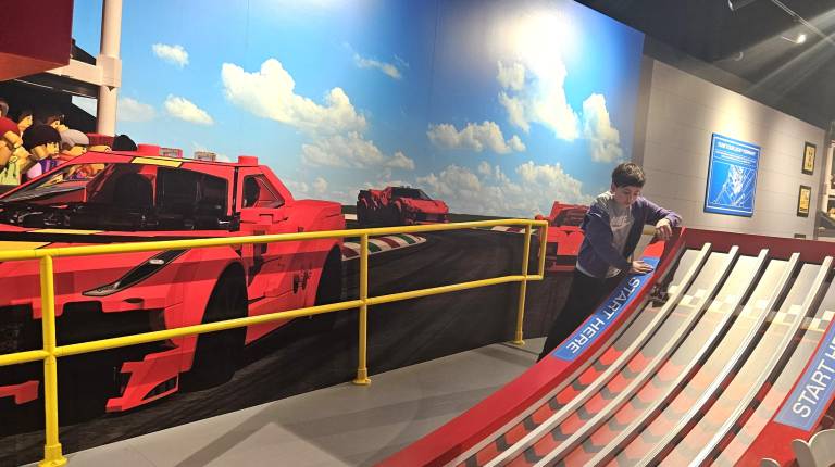 Guests can try out their model cars on test tracks within the attraction.