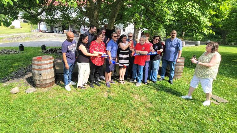 Local dignataries and community leaders celebrate ceremonial ribbon cutting at Sweet Clover Farm to kickoff America 250 celebrations.