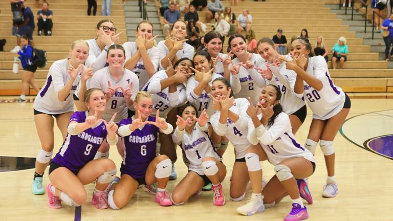 Crusader Volleyball team celebrates their 3-1 victory