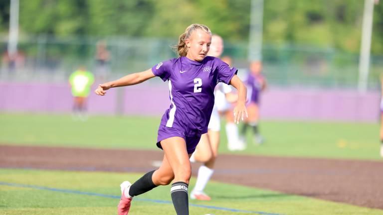 Crusader co-captain Amanda Sikorsky #2, attacks the Wildcat defense.