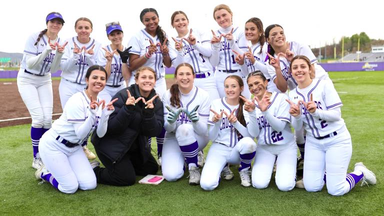 The Crusaders Varsity Softball celebrates their opening day victory over the Middies.