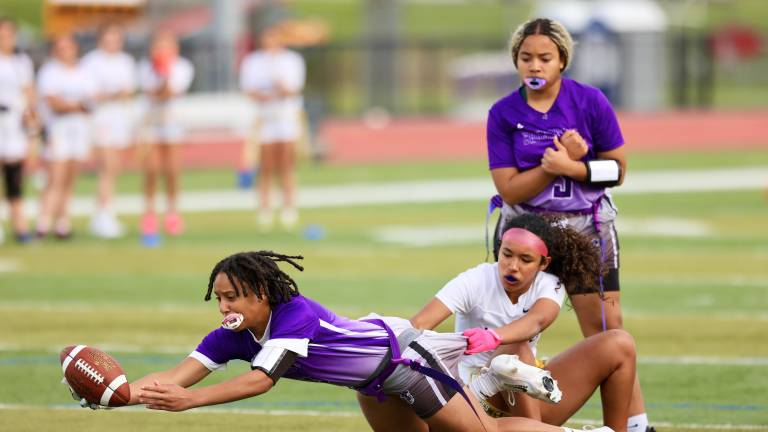 Kaitlyn Aybar dives into the end Zone to give the Crusaders a 19-7 lead in the third quarter.