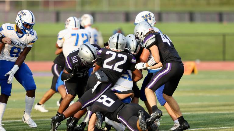 The Crusaders defense swarms over a Wizard ball carrier.