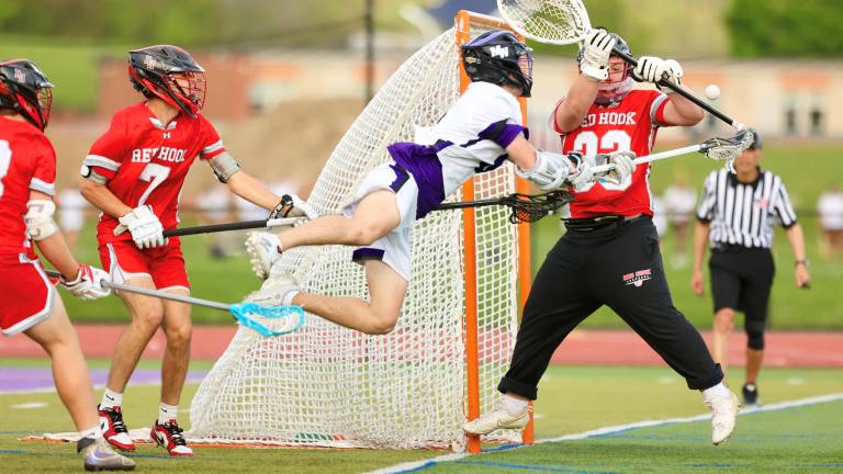 Luke Damiani dives in front of the Raiders goal and gets off a shot, the sophomore scored five goals in the game.