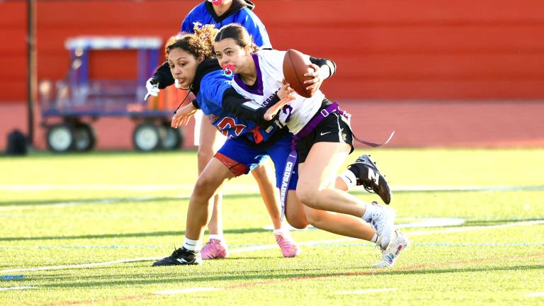Defensive back Ariana Torrellas #12,picks off a Gladiator pass in the first half.