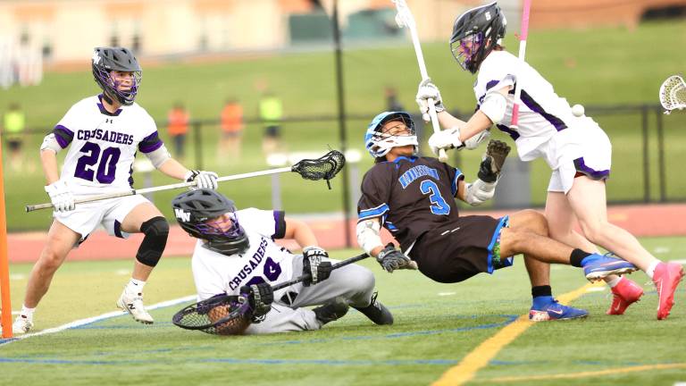Crusaders defenseman Anthony Schaffer clears the front of the Crusadsers goal with a hard check on a Middie.