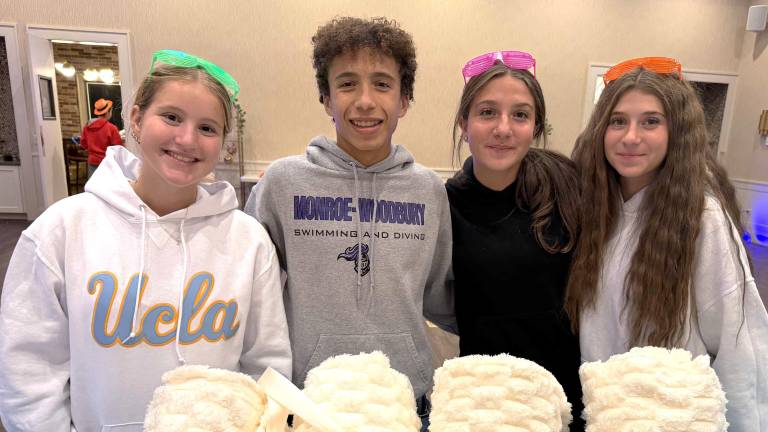 CTeen leaders Julia Olstein, Jaden Shaw, Lizzie Deskin and Gabi Patsiner, all of Monroe, direct a project of care packages designed for mothers of children with special needs.