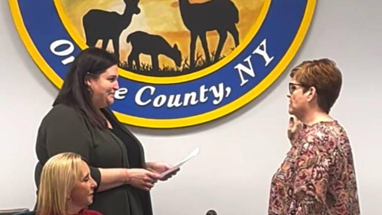 Kathleen Mottola (right) is sworn in by Village Clerk Jessica McCelennan as newly appointed Deputy Mayor Susan Ciriello looks on.