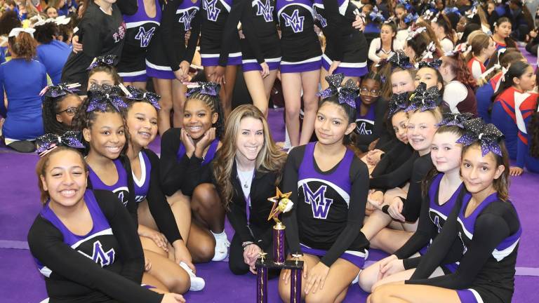 The Crusader Modified cheer team celebrities their victory.