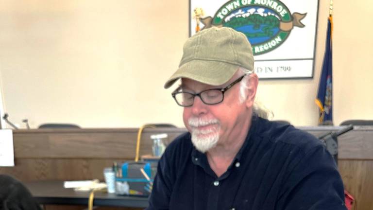 Monroe Repair Cafe volunteer Michael Fradianni fixes a jammed shredder on Dec. 6.